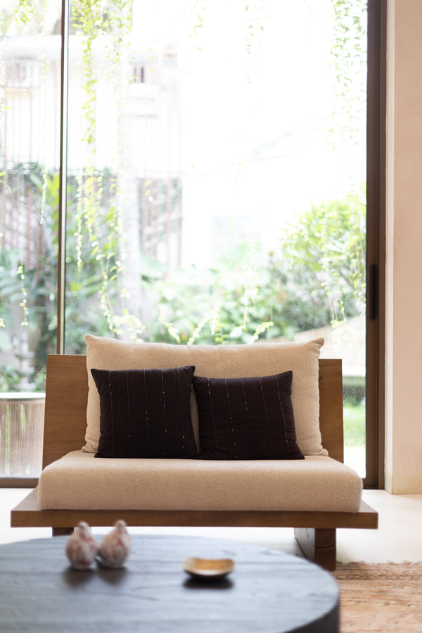Cushions in black Kotpad cotton, embellished with beadwork.