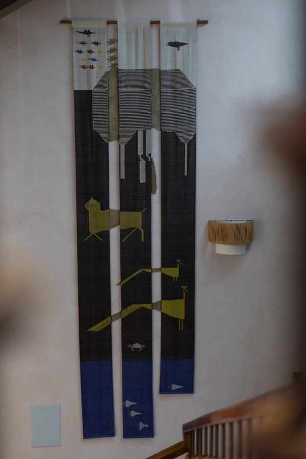 A forest landscape in fragmented vertical panels, interpreted through an assemblage of Kotpad textiles and Dhokra elements.