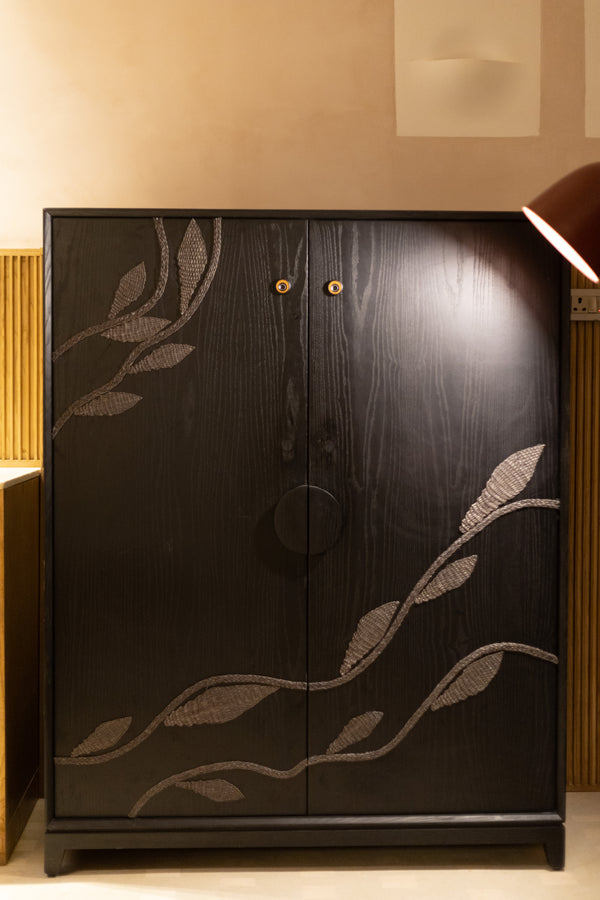 A creeping vine of resilient Sabai grass, woven over a wooden cabinet.